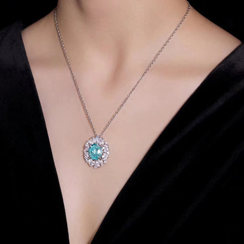 lady wearing Ocean blue cubic zirconia necklace with halo in silver