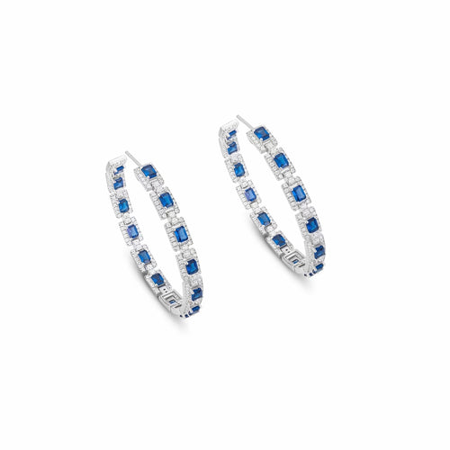 Side view of Blue sapphire silver drop earrings with moissanite