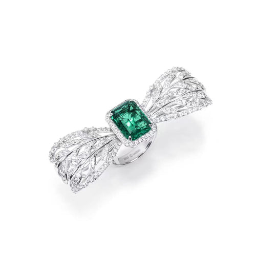 side view of Emerald engagement ring with moissanite halo in silver