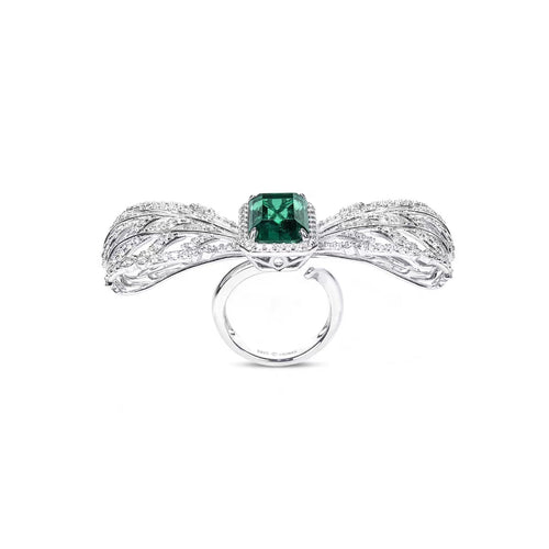 profile view of Emerald engagement ring with moissanite halo in silver