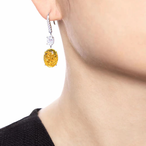 lady wearing Oval drop yellow zircon earrings in silver