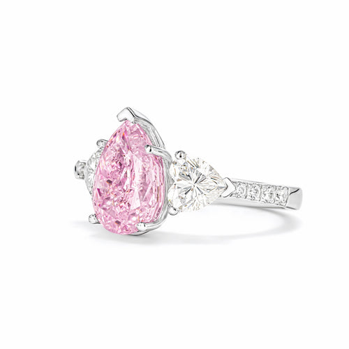 side view of Three stone silver engagement ring with pink zircon