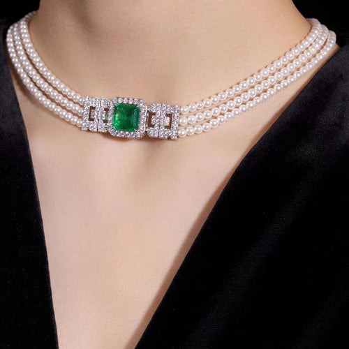 lady wearing Emerald and pearl necklace with moissanites