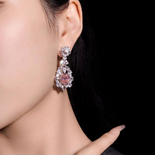 lady wearing Oval pink zircon drop earrings in silver 