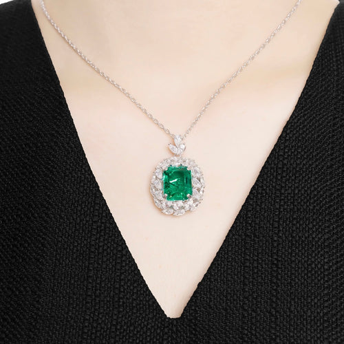 lady  wearing Emerald necklace with moissanite halo in silver