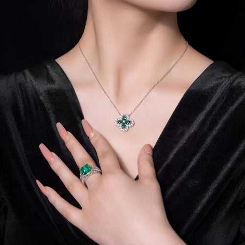 lady wearing Front view of Emerald green clover necklace with halo in silver