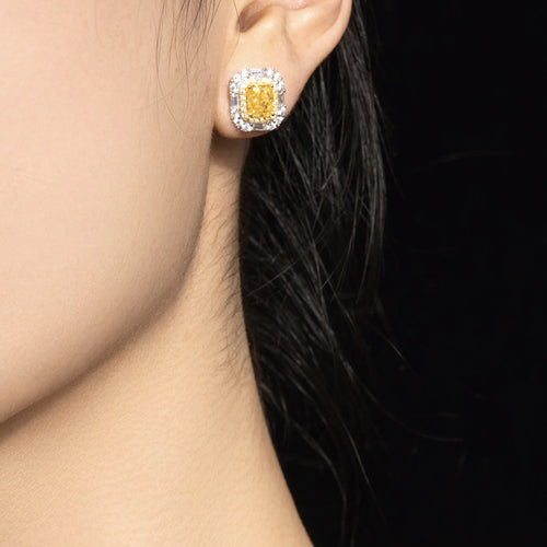 lady wearing Yellow zirconia halo stud earrings in silver