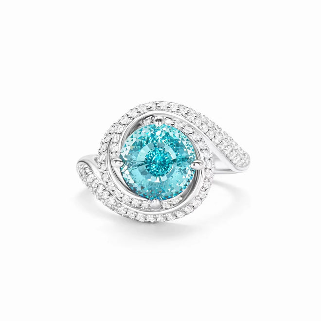 Engagement ring with round ocean blue zircon and swirl halo in silver