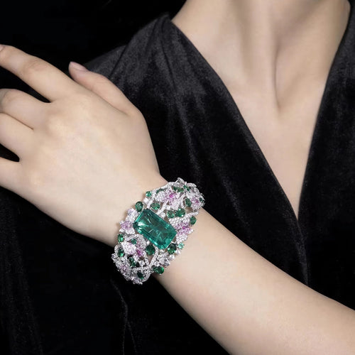 lady wearing Fancy emerald bangle with moissanites in silver 