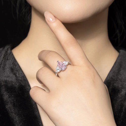 lady wearing Three stone silver engagement ring with pink zircon