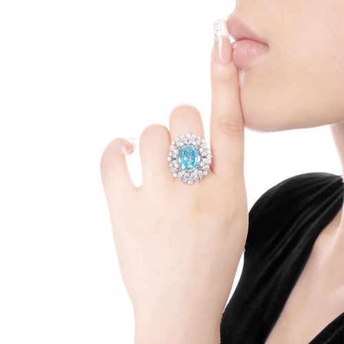 lady wearing Silver paraiba engagement ring with moissanites