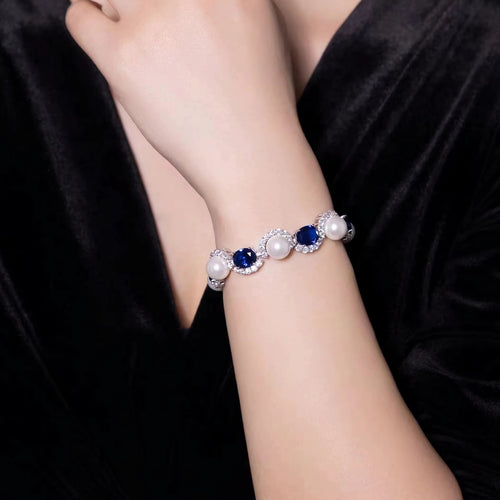 Lady wearing blue sapphire and pearl bracelet