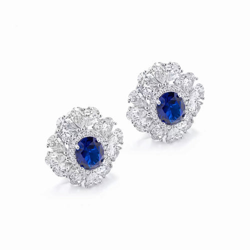 Side view of Blue sapphire silver earrings with moissanite halo