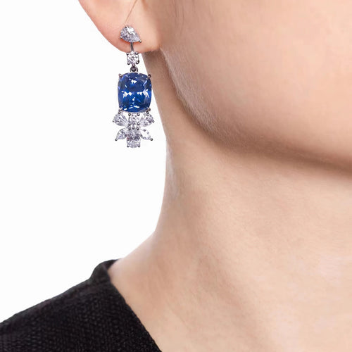 lady wearing Cushion blue zircon silver dangling earrings