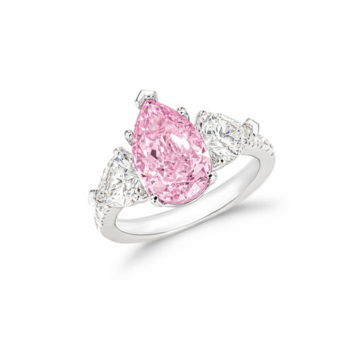 profile view of Three stone silver engagement ring with pink zircon