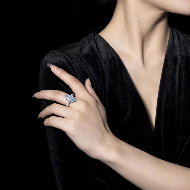 lady wearing Marquise blue cubic zirconia engagement ring in silver