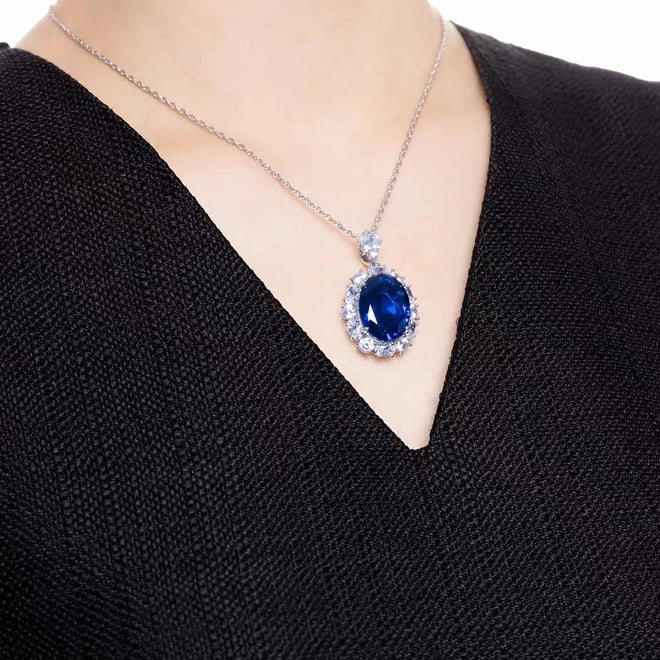 lady wearing Blue cubic zirconia halo necklace in silver