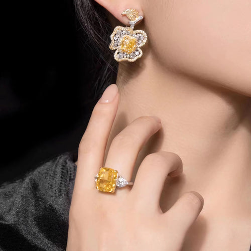 lady wearing Yellow zircon silver floral drop earrings with moissanites