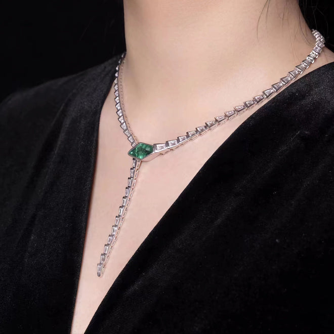 lady wearing Snake necklace with created emerald and moissanites