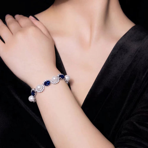 Lady wearing blue sapphire and pearl bracelet