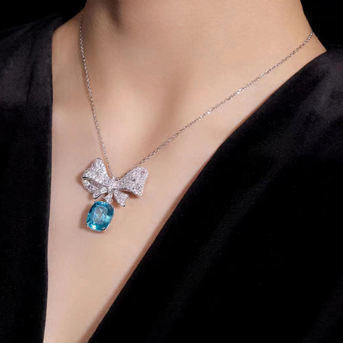 lady wearing Ocean blue cubic zirconia butterfly necklace in silver