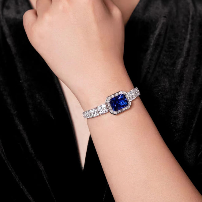 lady wearing Blue zircon silver bracelet with moissanite halo