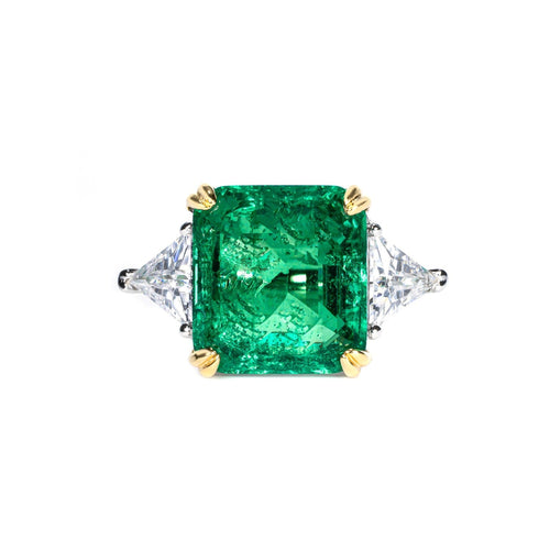 Emerald engagement ring with trillion side stone in silver