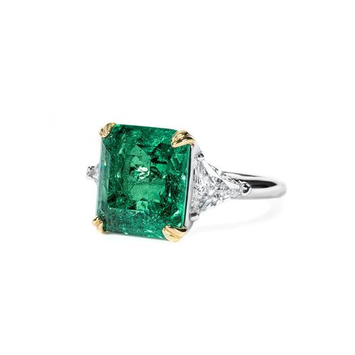 side view of Emerald engagement ring with trillion side stone in silver