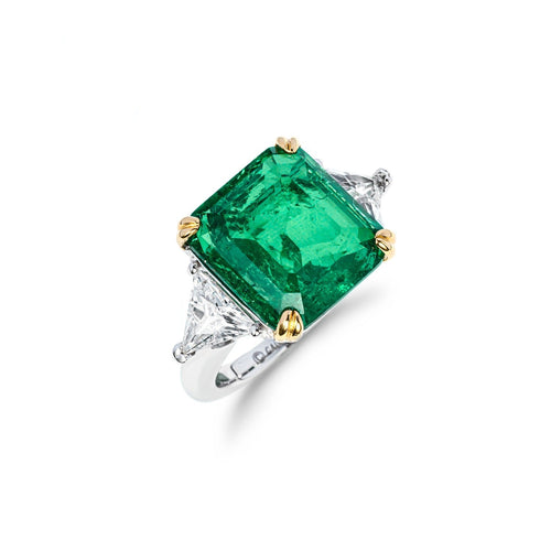 profile view of Emerald engagement ring with trillion side stone in silver