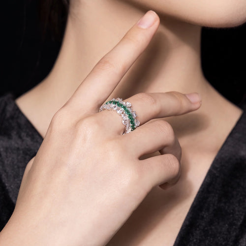 lady wearing Emerald wedding ring with moissanite in silver, eternity band