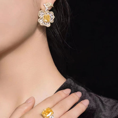 lady wearing Yellow zircon silver floral drop earrings with moissanites