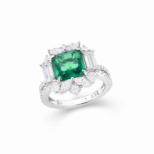 side view of Emerald engagement ring with moissanite halo in silver