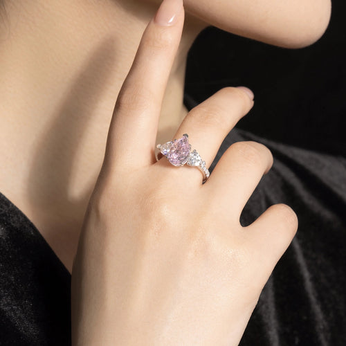 lady wearing Three stone silver engagement ring with pink zircon