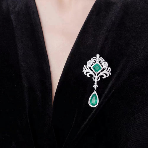 lady wearing Emerald brooch with moissanite in silver