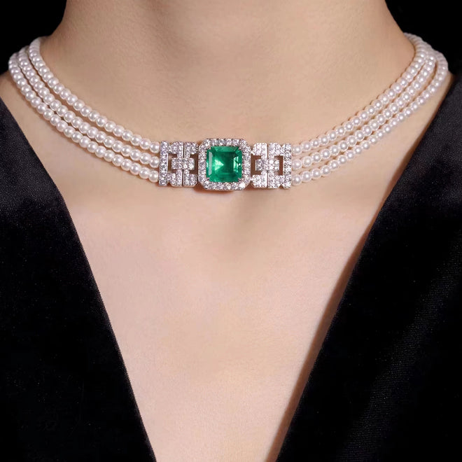 lady wearing Emerald and pearl necklace with moissanites