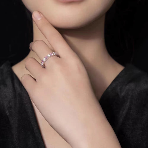 lady wearing Alternating round pink and  white zircon silver ring