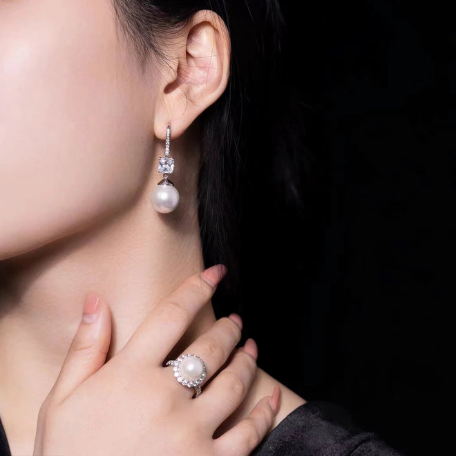 lady wearing Pearl drop earrings with princess cut zirconia