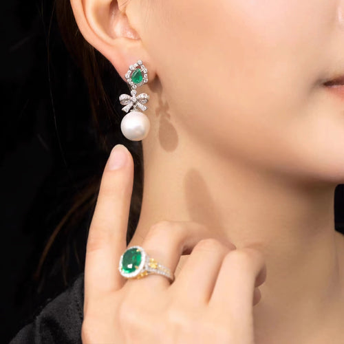 lady wearing Created pearl drop earrings with emerald in silver