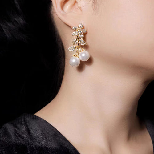 lady wearing Leafy pearl drop earrings in silver